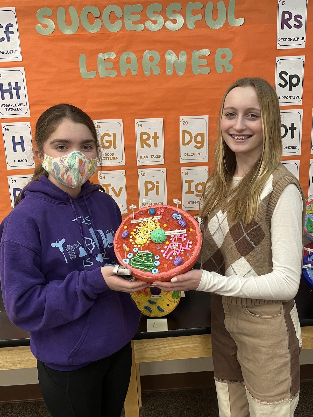 Sydney Mularski and Riley Joyce show the cell model they created