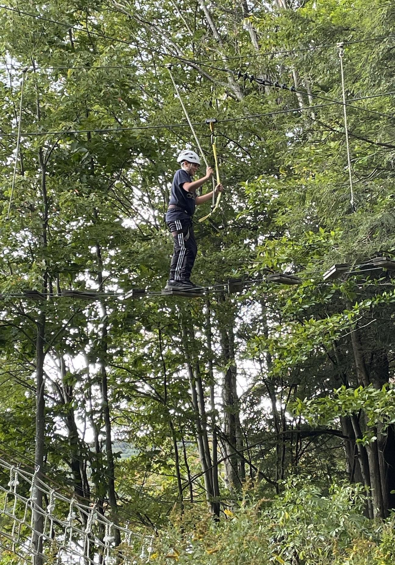 A student on the high ropes course