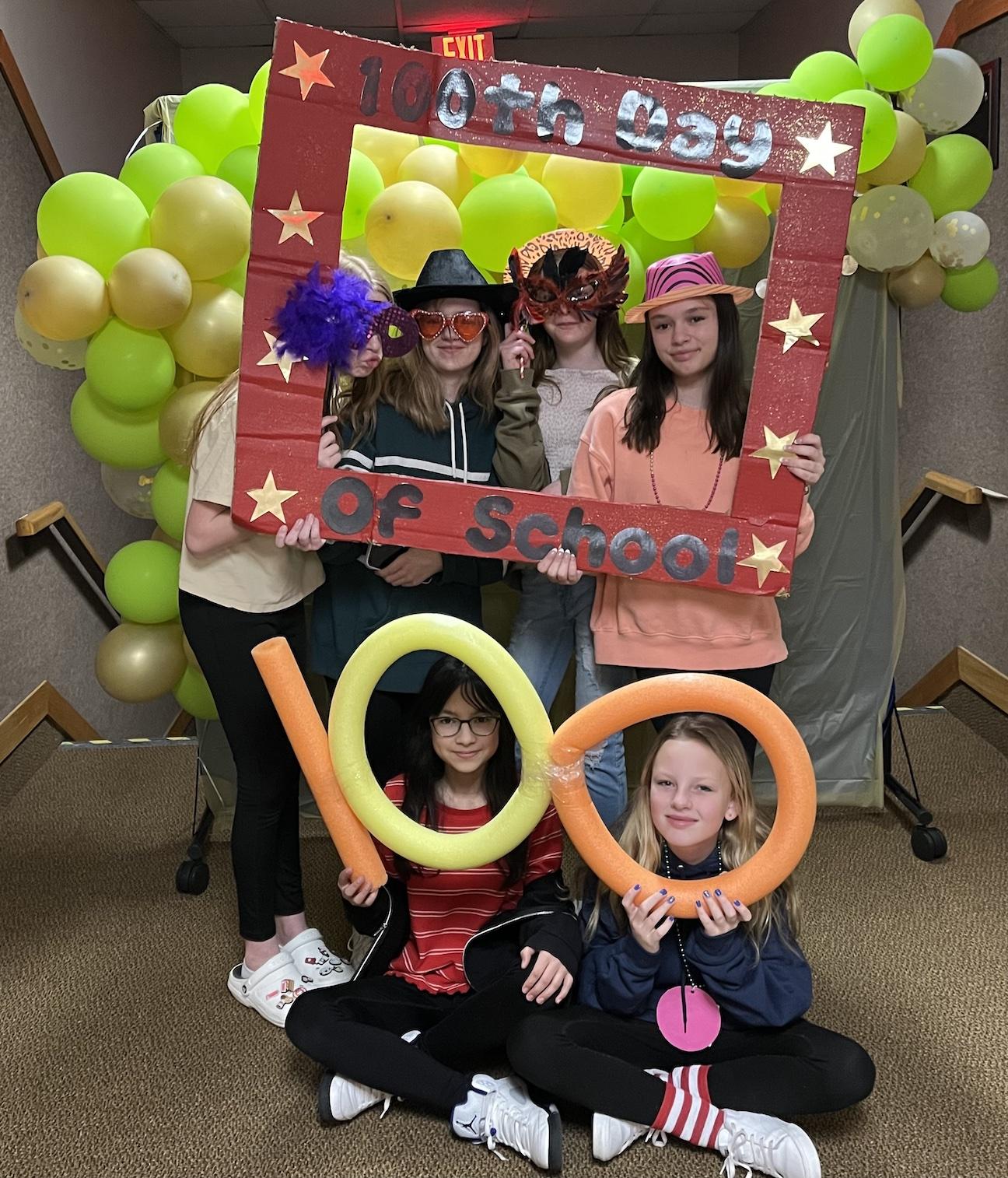 Penn Middle School students enjoyed the 100th-Day photo booth; (Back) Sammi Funk, Charlie Crystaloski, Olivia Price, Megan Prater, (Front) Elena Valdiserri, Kayla Kennelly