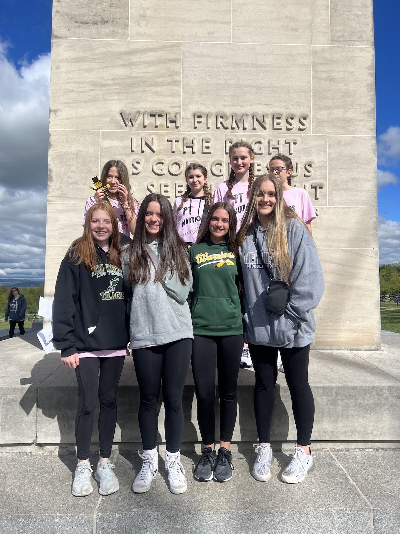 Gathered at the Eternal Light Peace Memorial are Trafford students (front) Sydney Gill, Ava Cafaro, Teresa Fiori, and Josie Schubert, (back) Charlie Thomas, Adele Lee, Ryleigh Susalla, and Haleigh Weagraff